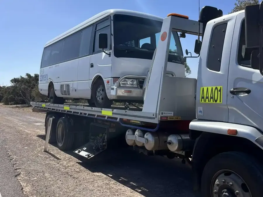 AMAX tilt tray truck towing a Fuso bus in Whyalla